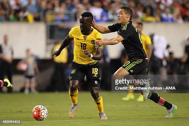 Simon Dawkins of Jamaica and Jesus Duenas of Mexico during the 2015 CONCACAF Gold Cup Final match between Jamaica and Mexico at Lincoln Financial...