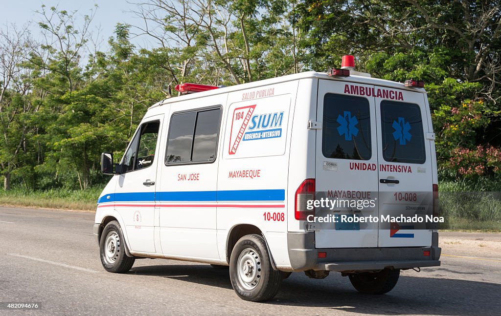 Everyday Cuban scenes: White ambulance part of the health...