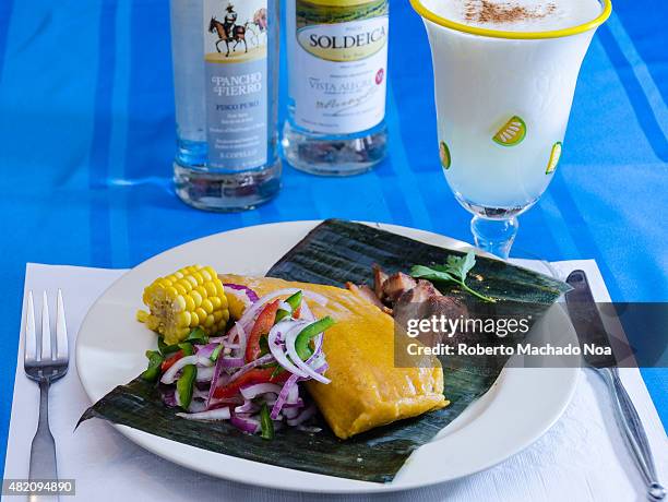 Tamal or tamales and a Pisco Sour cocktail, tamales in a corn dough made traditional and popular dish in Latin America.