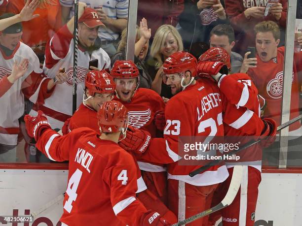 Gustav Nyquist of the Detroit Red Wings scores a third period game winning goal and is congratulated by his teammates during the game against the...