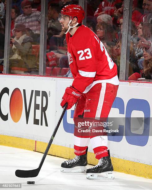 Brian Lashoff of the Detroit Red Wings handles the puck behind the net during an NHL game against the Boston Bruins on April 2, 2014 at Joe Louis...