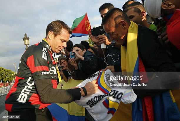 Cadel Evans of Australia signs autographs for fans following stage twenty one of the 2015 Tour de France, a 109.5 km stage from Sevres to the Champs...