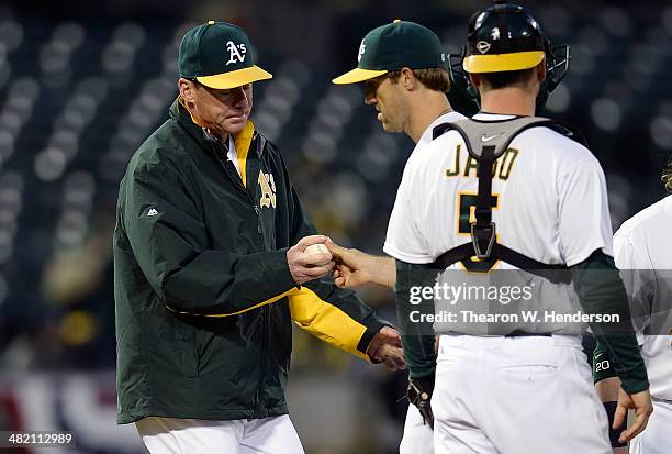 Manager Bob Melvin of the Oakland Athletics takes the ball from pitcher Josh Lindblom taking him out of the game in the top of the fifth inning...
