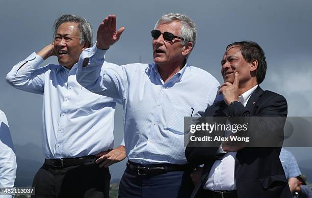 Secretary of Defense Chuck Hagel watches a flight demonstration of MV-22 Osprey tiltrotor V/STOL aircrafts on the flight deck of the USS Anchorage ,...