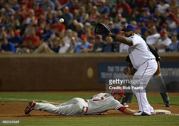 Jayson Nix of the Philadelphia Phillies dives back to first in the sixth inning beating the throw to Prince Fielder of the Texas Rangers at Globe...