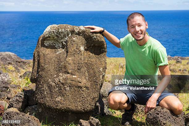 handsome traveler with a moai face in ahu te peu - easter_island stock pictures, royalty-free photos & images