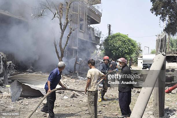 Syra Syrian firefighters extinguish the fire after Assad forces attack to Douma district of East Ghouta, Damascus, Syria, on July 27, 2015.
