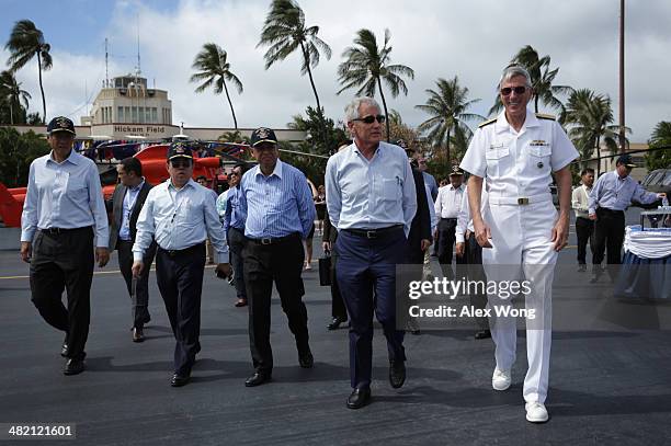 Accompanied by Commander of U.S. Pacific Command Admiral Samuel Locklear , U.S. Secretary of Defense Chuck Hagel participates in a tour with his...