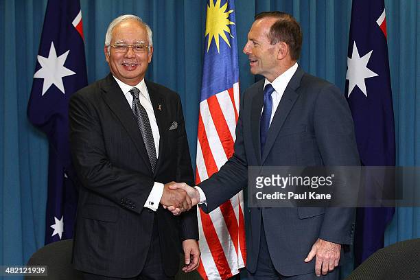 Malaysian Prime Minister Najib Razak and Australian Prime Minister Tony Abbott shake hands before a bilateral meeting held at the Commonwealth...