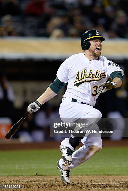 Brandon Moss of the Oakland Athletics reacts after fouling a ball off his foot against the Cleveland Indians in the bottom of the seventh inning at...