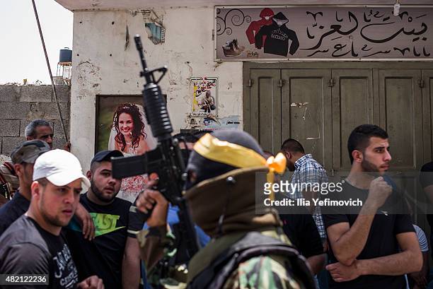 Masked gunmen seen during the funeral of Mohammed Lafi Abu Latifeh on July 27, 2015 in Kalandia, West Bank. Mohammed was shot during an arrest by...