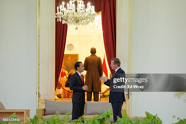 Indonesian President Joko Widodo, left and British Prime Minister David Cameron chat before bi-lateral meetings outside the Presidential Palace on...