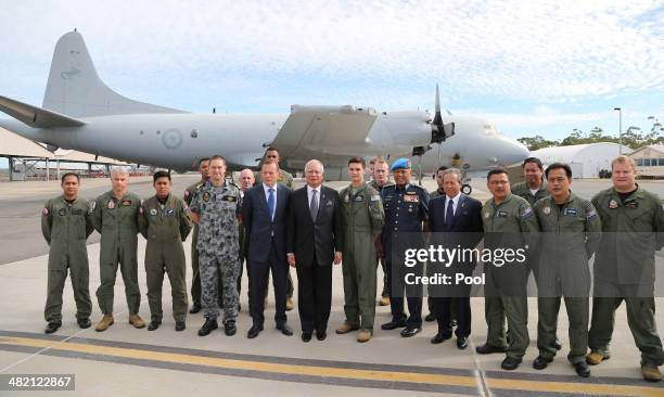 Malaysia Prime Minister Najib Razak and Australian Prime Minister Tony Abbott pose for a photo with a RAAF P3 Orion crew and RMAF C-130 crew involved...