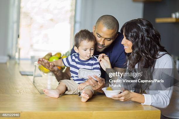 Tony Parker with his wife Axelle Francine and their son Josh are photographed for Paris Match in their new property on july 15, 2015 in near...