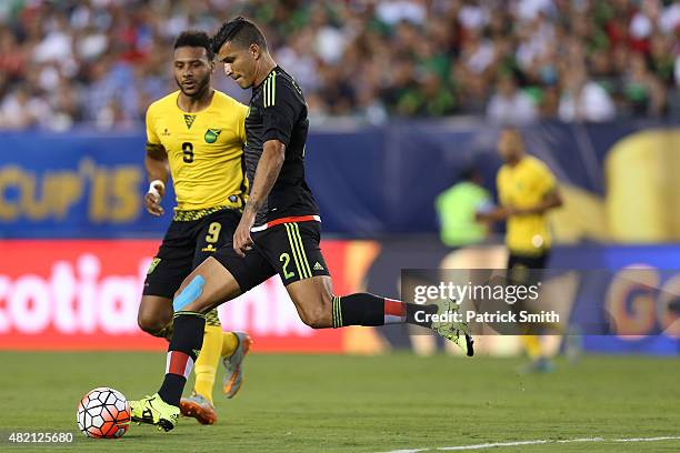 Francisco Javier Rodriguez of Mexico passes in front of Giles Barnes of Jamaica during the CONCACAF Gold Cup Final at Lincoln Financial Field on July...