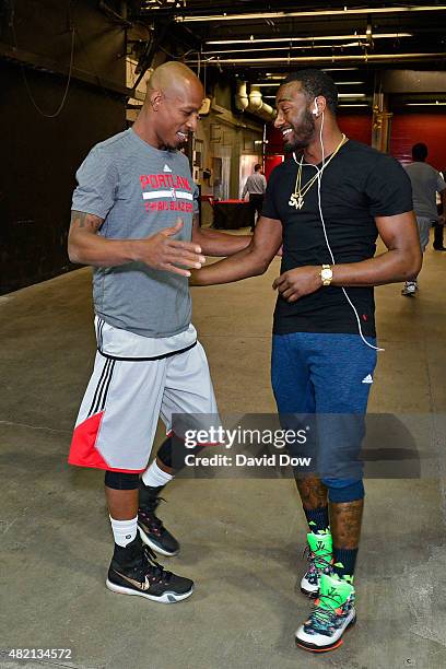 Keith Bogans of the Portland Trail Blazers talks to John Wall of the Washington Wizards during the 2015 Summer League at The Cox Pavilion on July 15,...
