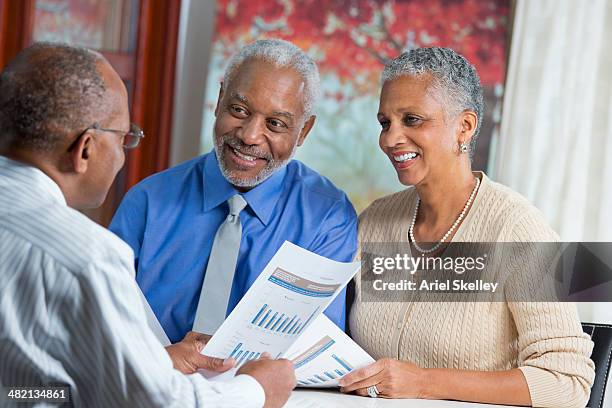 black couple talking to businessman - senior financial planning stock pictures, royalty-free photos & images