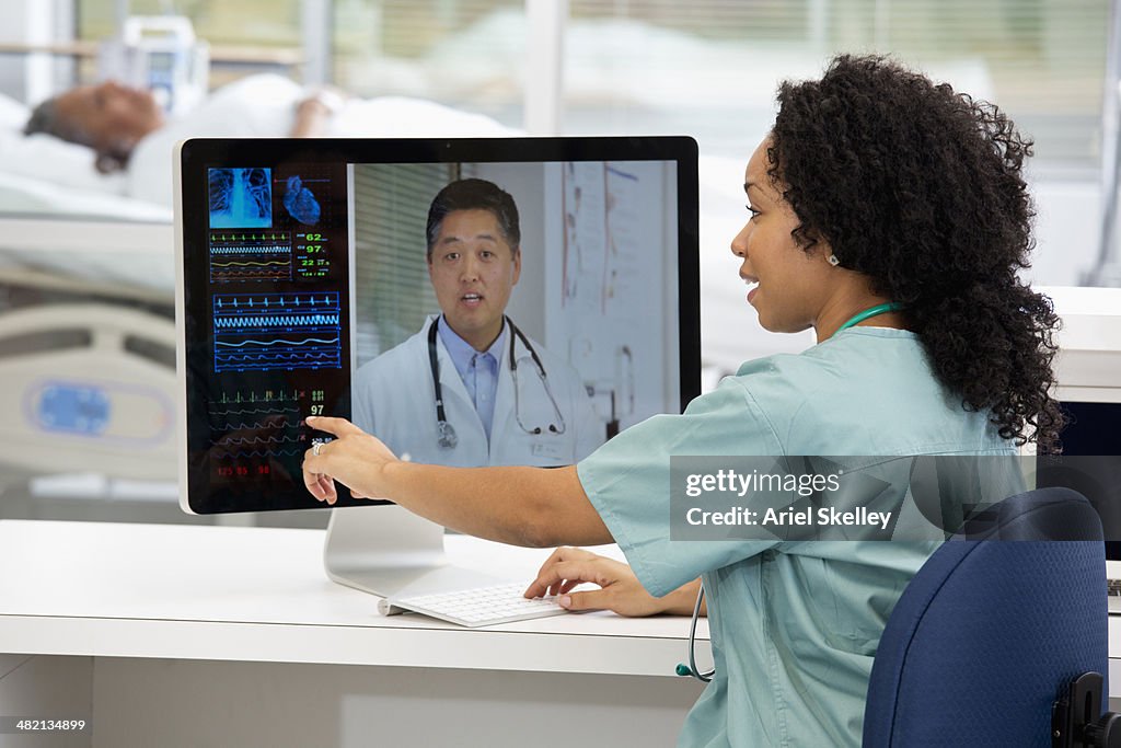 Nurse having teleconference with doctor in hospital