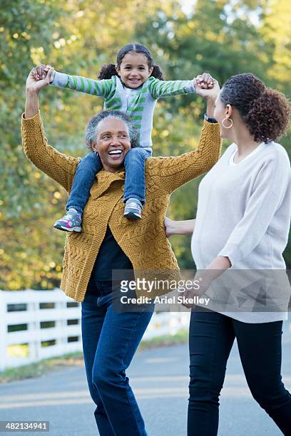three generations of women walking together - angelica hale fotografías e imágenes de stock