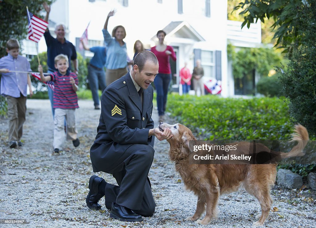 Caucasian family greeting returning soldier