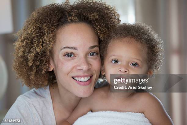 black mother and daughter smiling together - baby on white stock-fotos und bilder