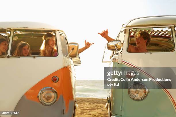 people making hand gestures in vans on beach - japanese girls hot fotografías e imágenes de stock