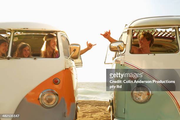 people making hand gestures in vans on beach - friends waving stock pictures, royalty-free photos & images