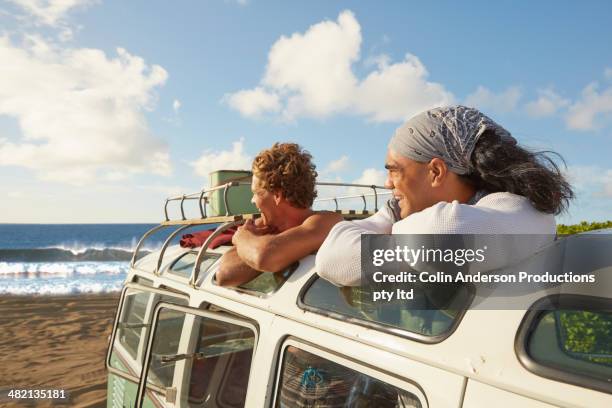 Men standing in van outdoors