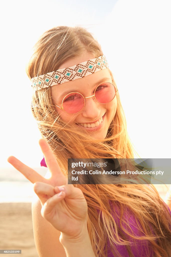 Caucasian woman making peace sign