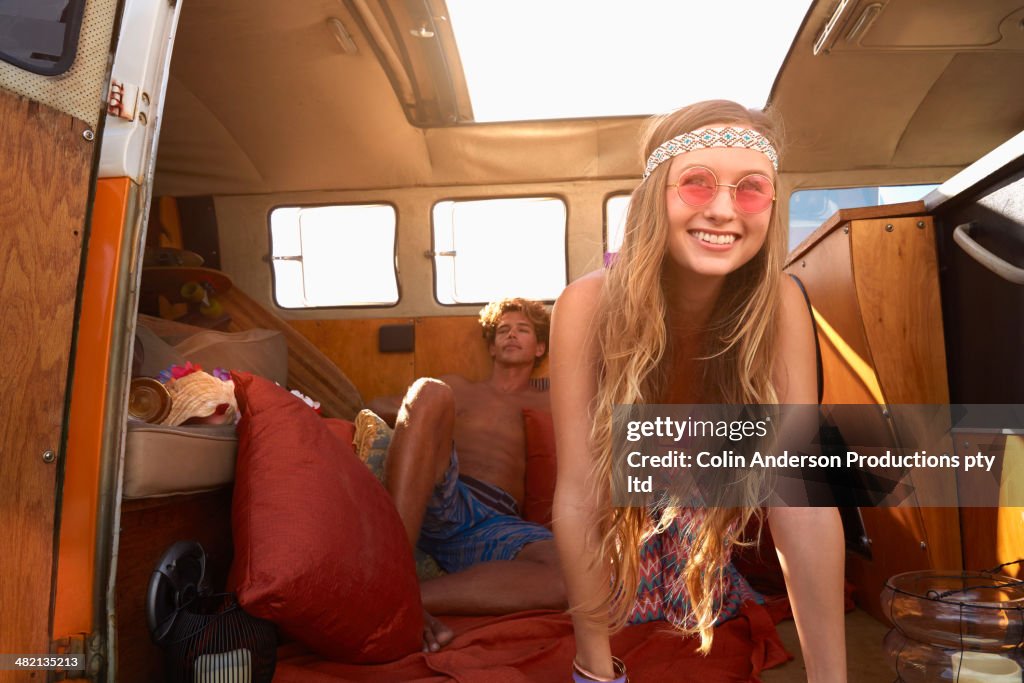 Caucasian couple relaxing in van