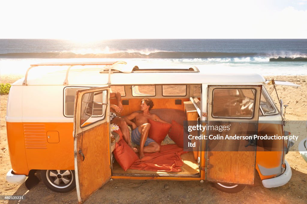 Men relaxing together in van