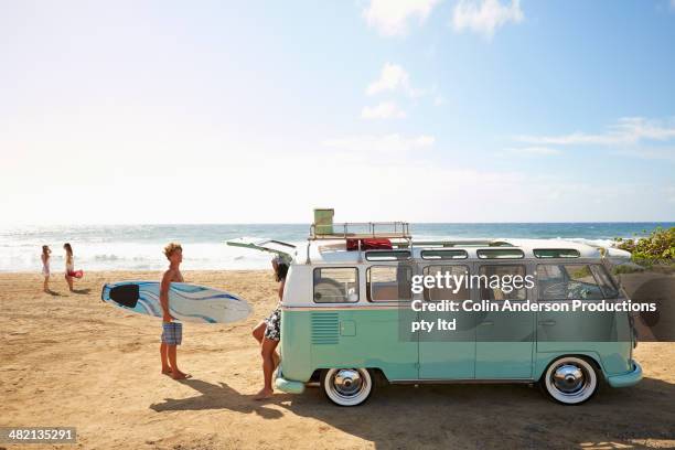 friends with van relaxing on beach - honolulu stock pictures, royalty-free photos & images