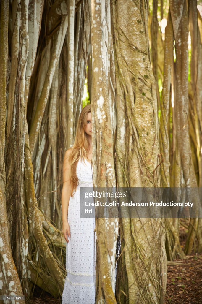Caucasian woman standing under banyan tree