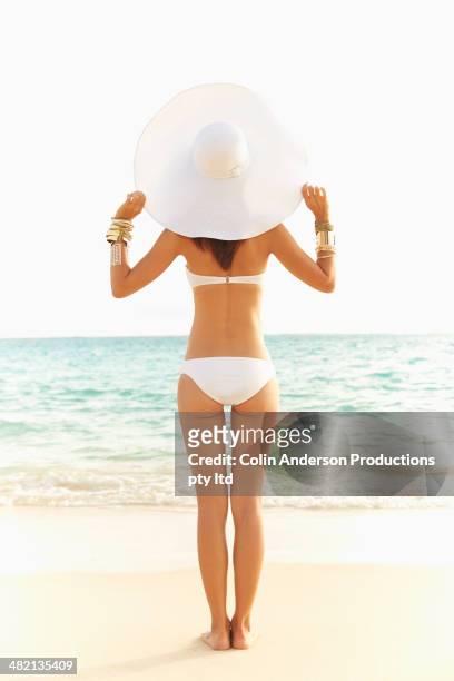 japanese woman in bikini and sun hat on beach - women's swimwear stock pictures, royalty-free photos & images