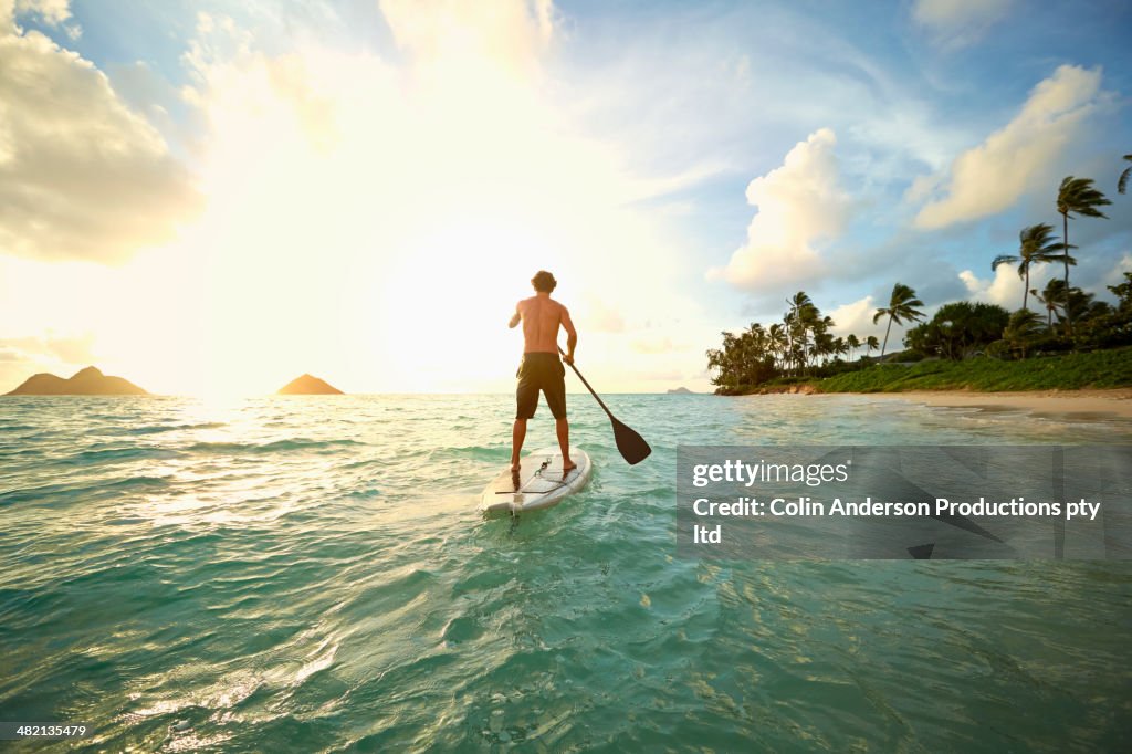 Caucasian man on paddle board in ocean