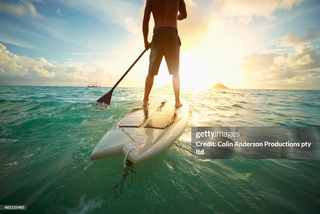 Caucasian man on paddle board in ocean