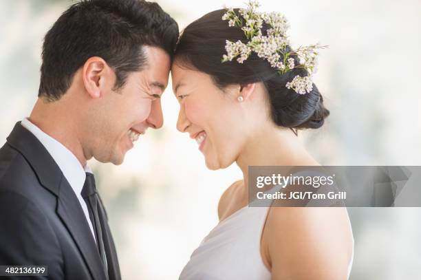 newlywed couple smiling face to face - interracial wife fotos stockfoto's en -beelden