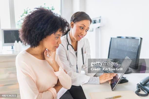 african american doctor and patient talking in office - doctor and patient talking imagens e fotografias de stock