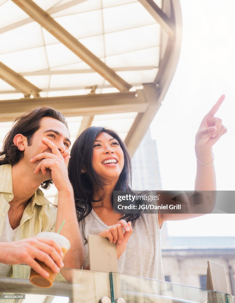 Couple pointing and looking up