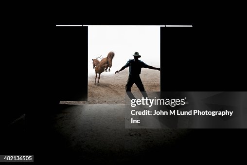 Caucasian rancher closing barn door Caucasian rancher closing barn door