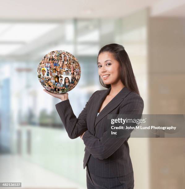 businesswoman holding ball of business people's faces - world social media day stock pictures, royalty-free photos & images