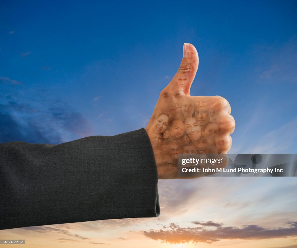 Business people's faces in thumbs up