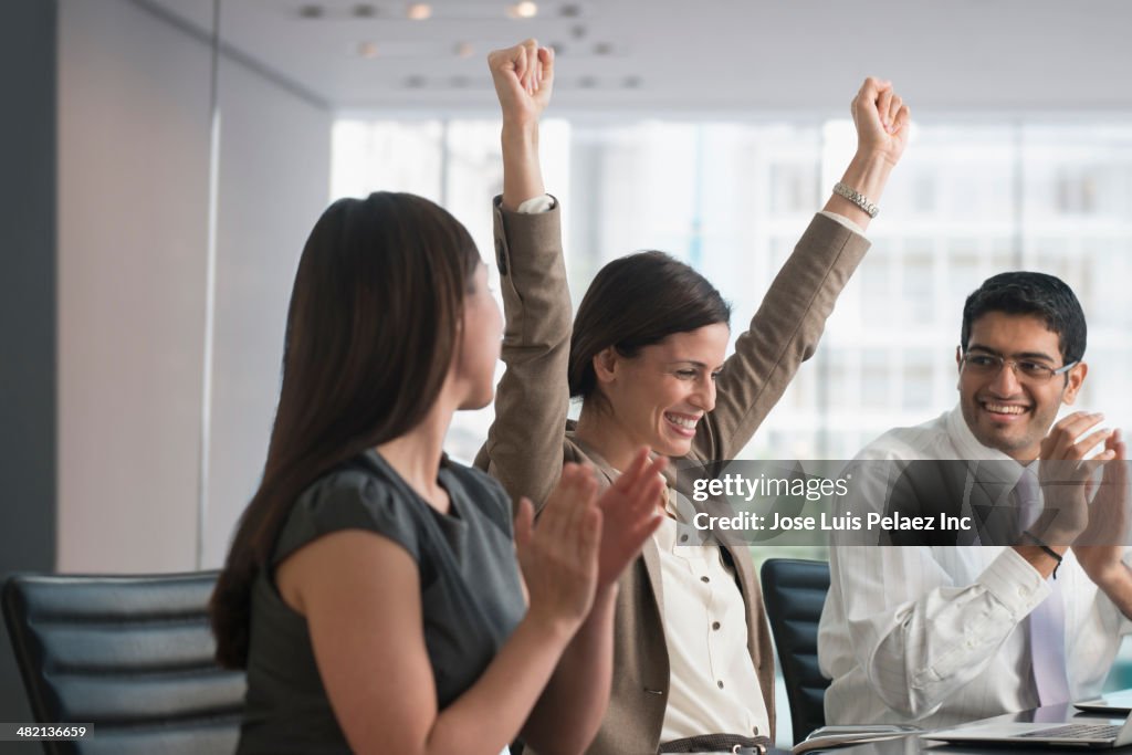 Business people cheering in meeting