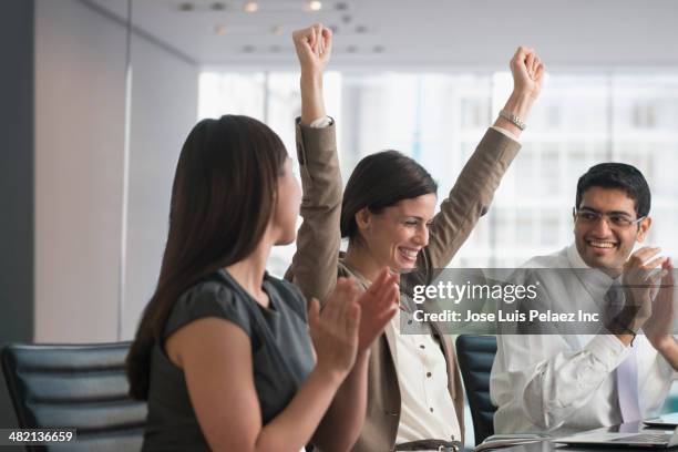 business people cheering in meeting - congratulations winner stock pictures, royalty-free photos & images