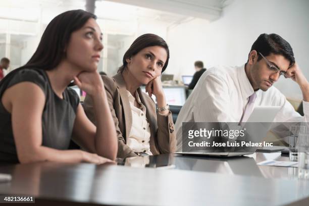 business people sitting in meeting - bored worker fotografías e imágenes de stock