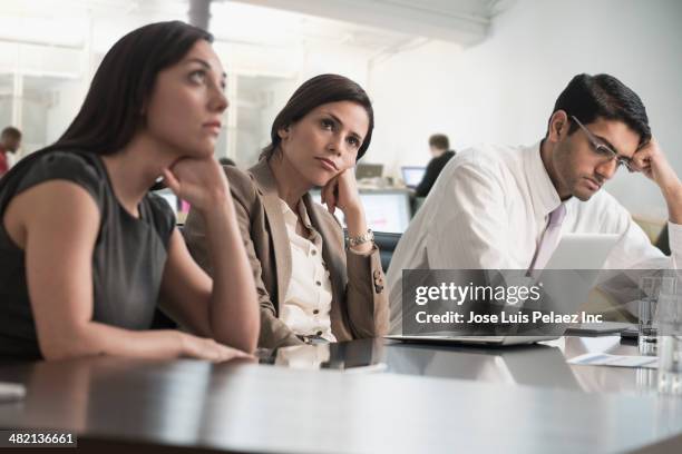 business people sitting in meeting - bored imagens e fotografias de stock