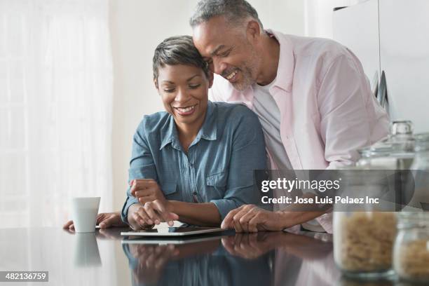 african american couple using digital tablet - new jersey home stock pictures, royalty-free photos & images