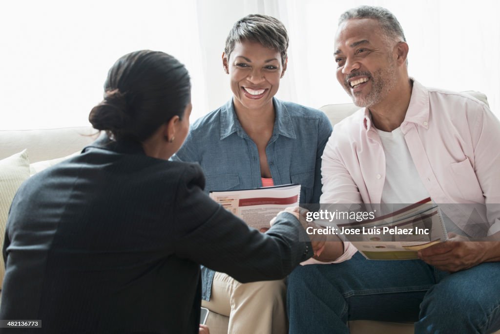 African American couple talking to businesswoman