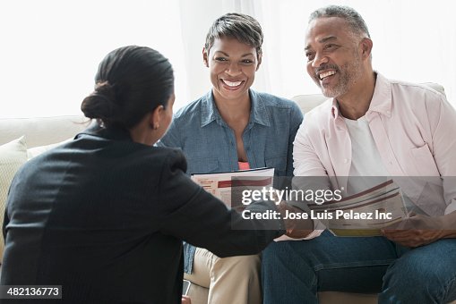 African American couple talking to businesswoman African American couple talking to businesswoman