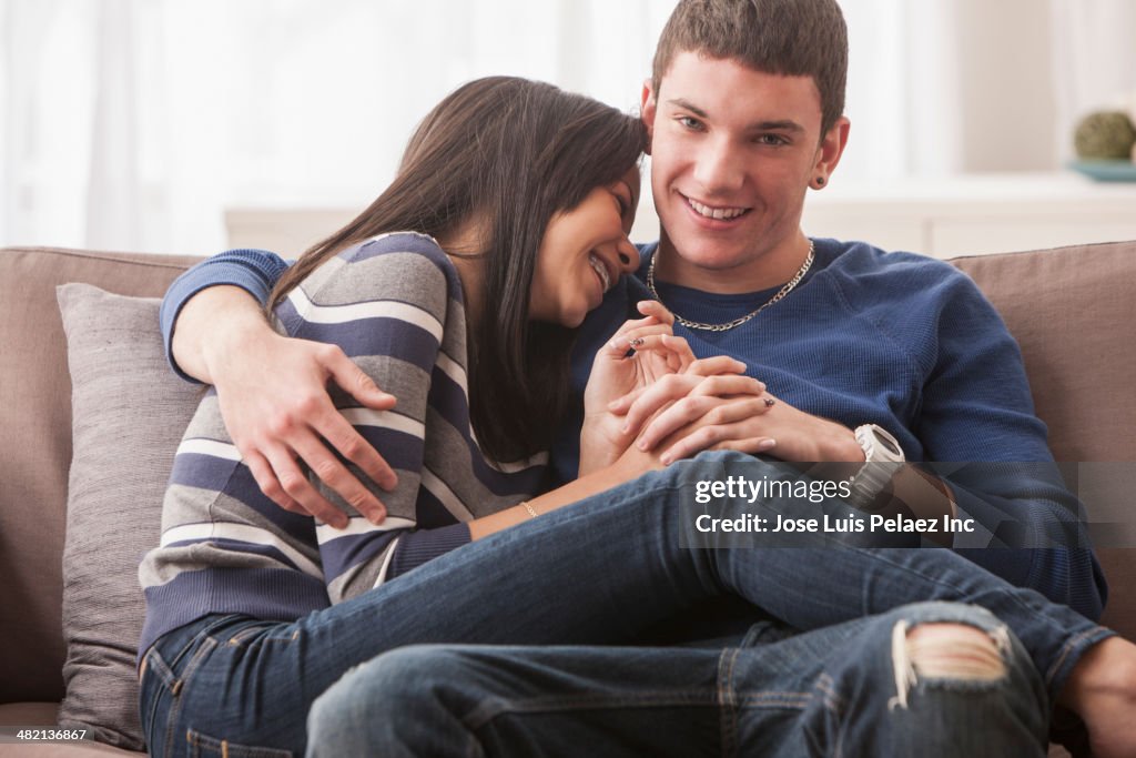 Teenage couple relaxing on sofa